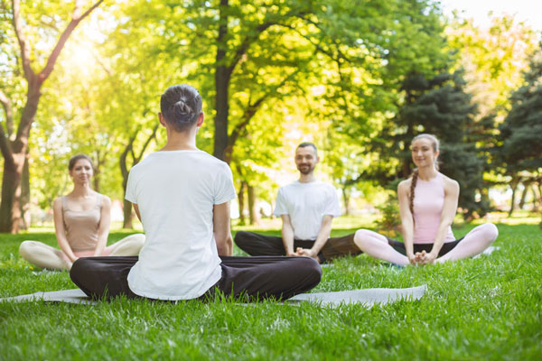 Group participates in outdoor community yoga