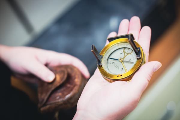 Student holds compass from archives