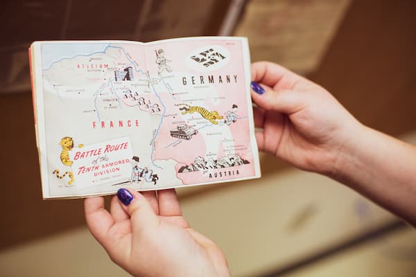 hands holding a historical map of europe