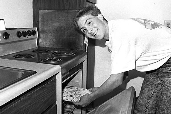 Student baking pizza in the traditional apartments