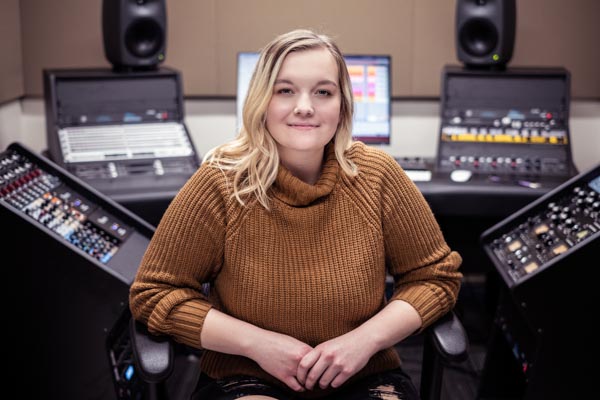 UWGB student seated in an audio production booth