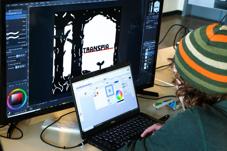 Student works on computer developing video game
