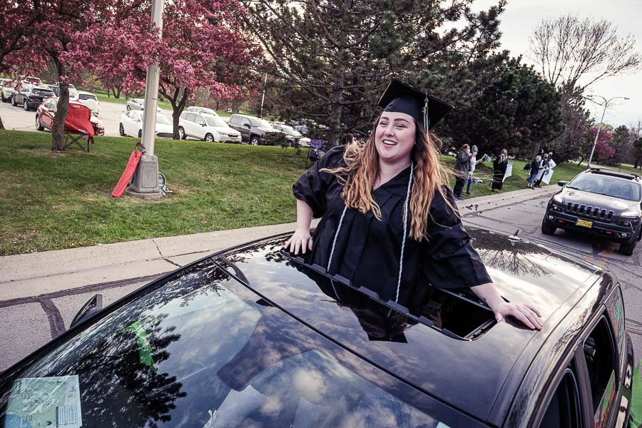 Graduate celebrating through the moon roof