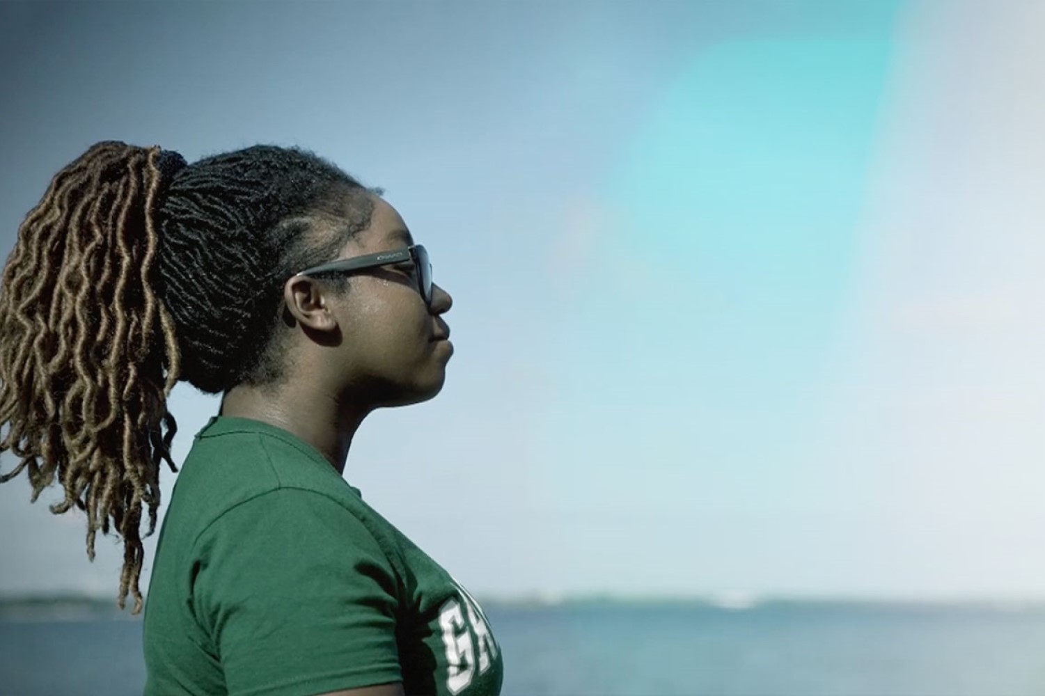 Student standing by Lake Michigan