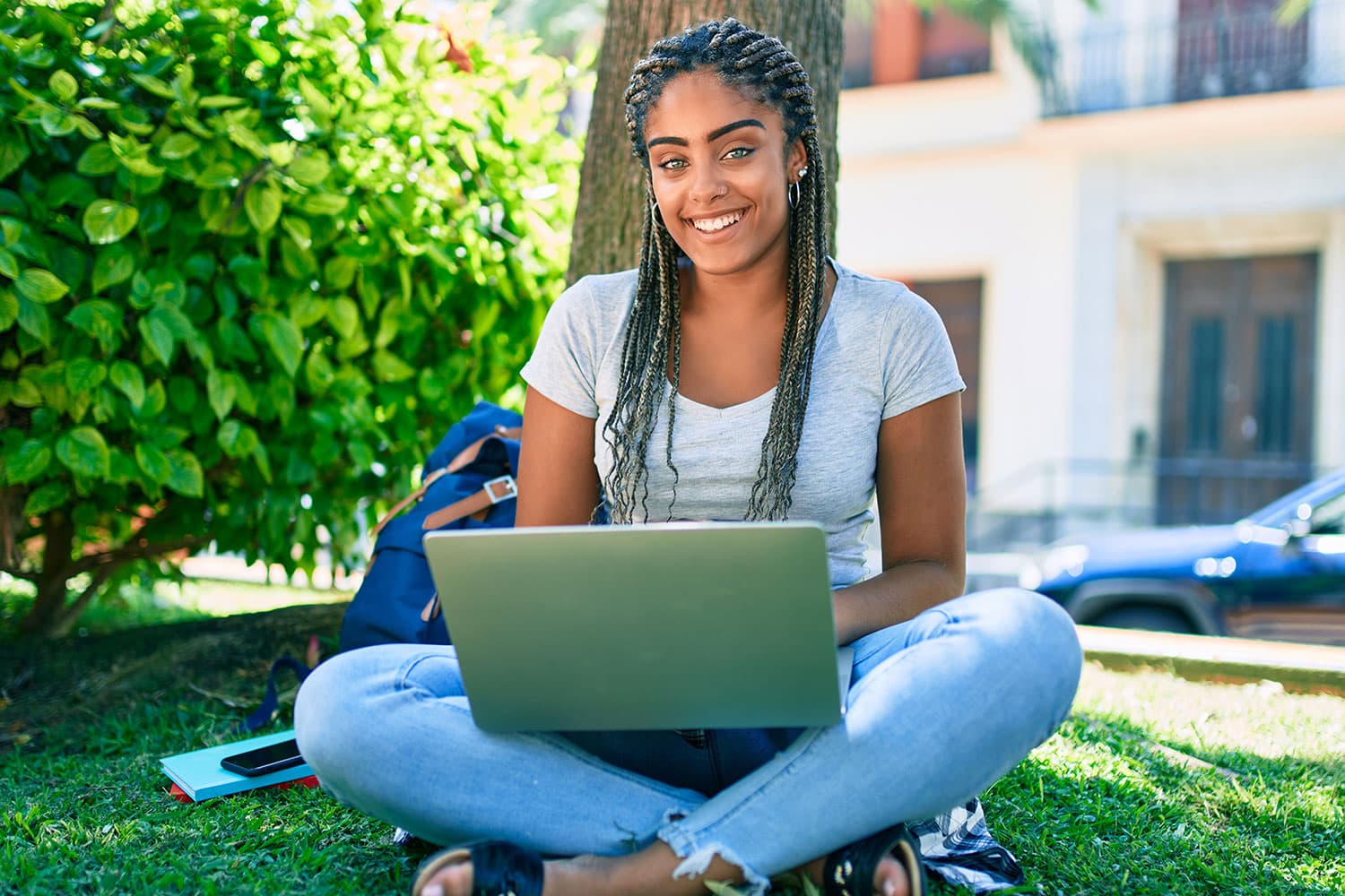 Female student sitting outside studying