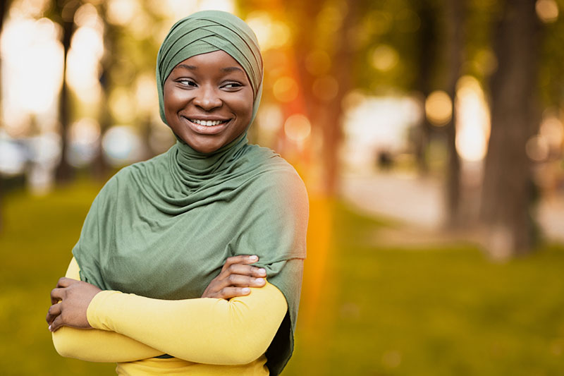 Modern muslim woman standing outside