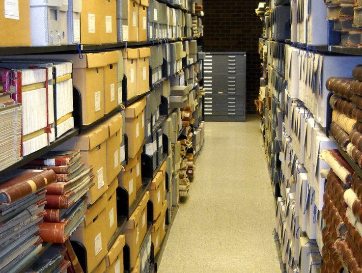 Archival documents stacks on shelves