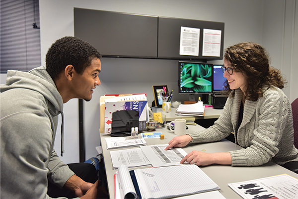 An Academic Advisor helps a student with his academics