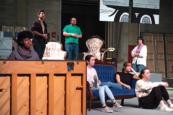 Theater students on stage practicing their roles