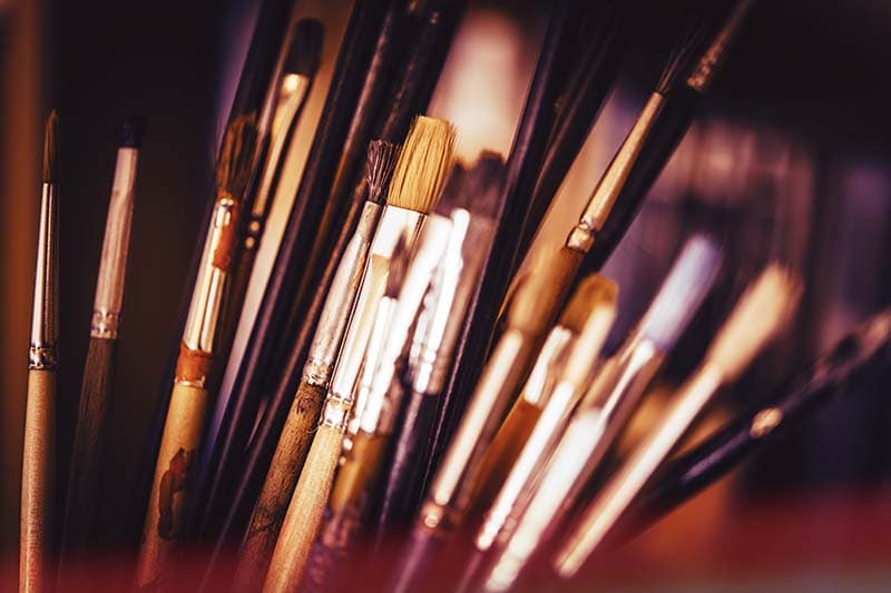 close up of multiple paint brushes