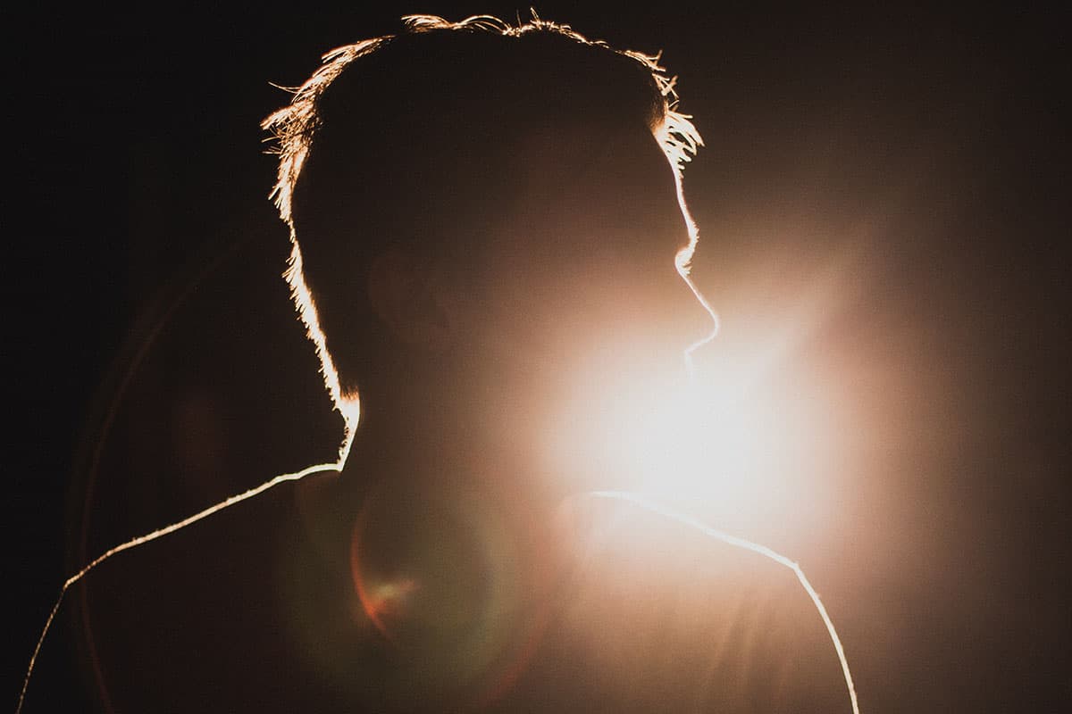 person backlit by stage lights