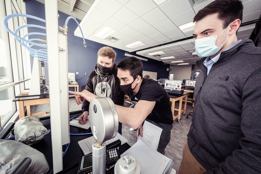 Engineering students using simulation equipment to understand physical effects of engineering concepts