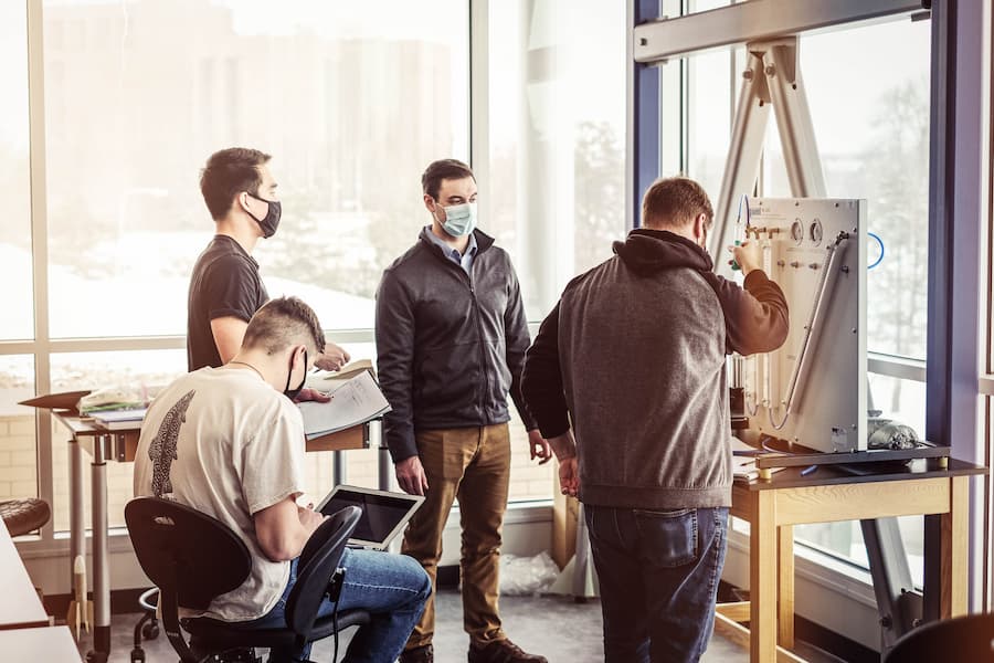 Four male students work on engineering project