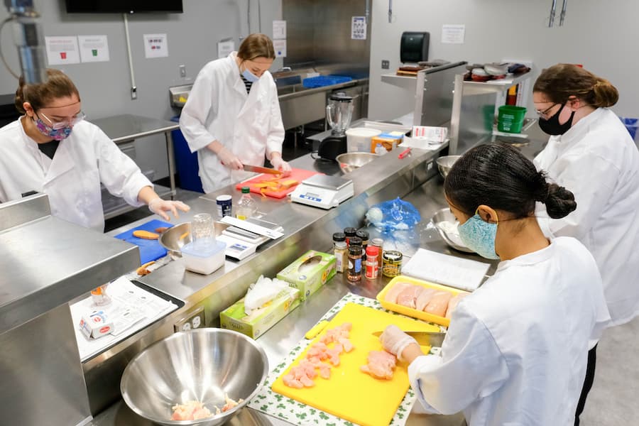 Group of students prepare food in STEM Center Kitchen