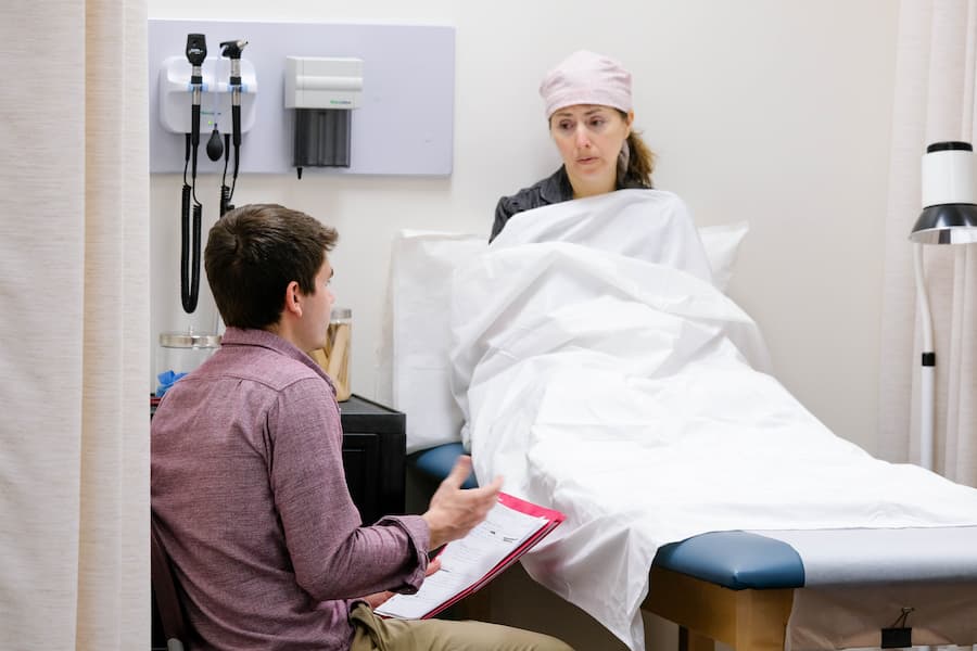 Male student works in clinical environment