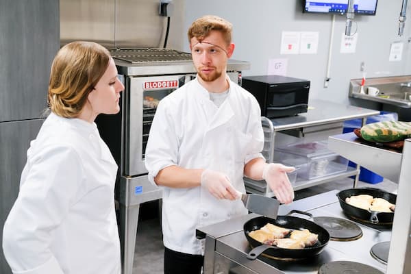 Students discuss dish in STEM Center Kitchen