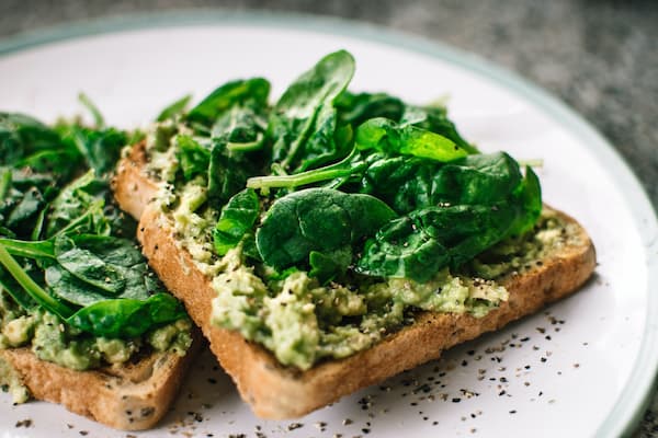 Avacado toast topped with baby spinach
