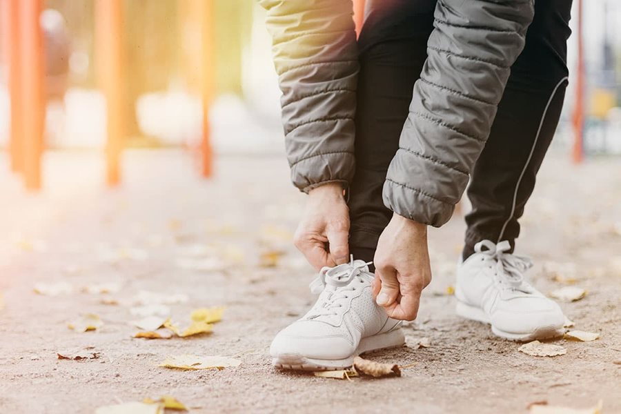 woman tying her shoelaces