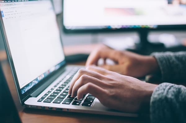 Hands poised on a laptop keyboard