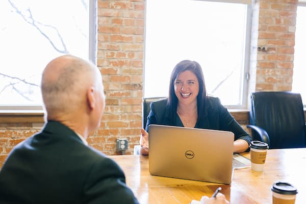 Man and woman smile together during a meeting
