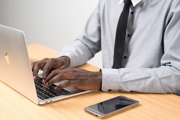 Professional typing on laptop