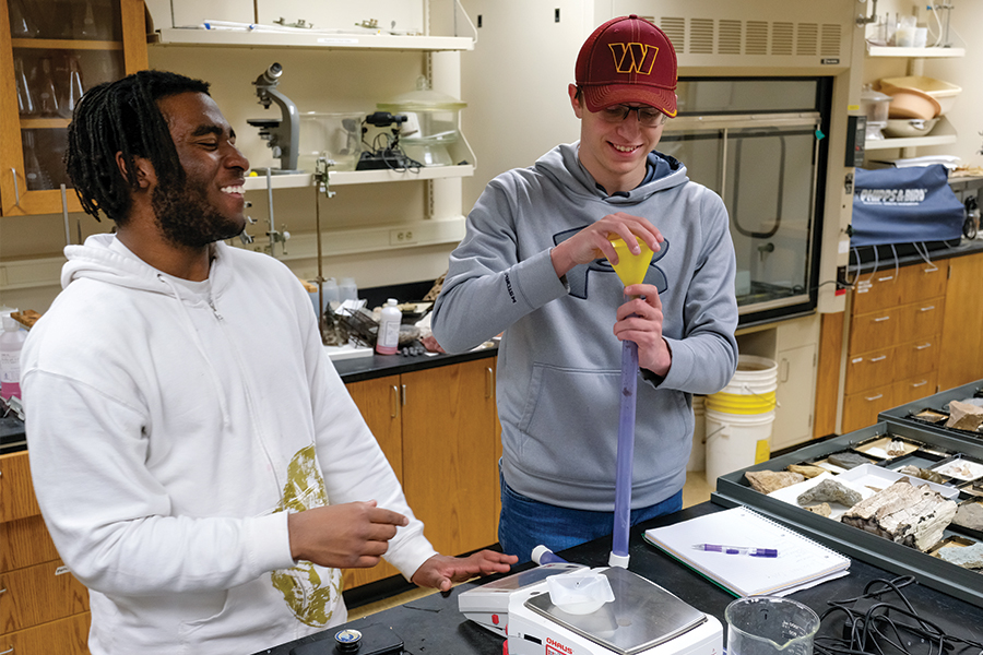 Two students participating in a sustainable water management exercise.