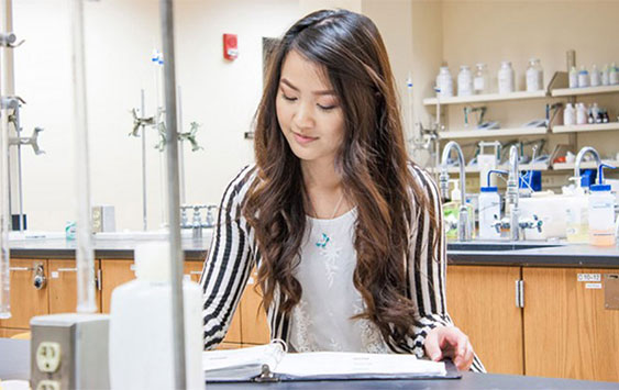 Female student taking lab notes