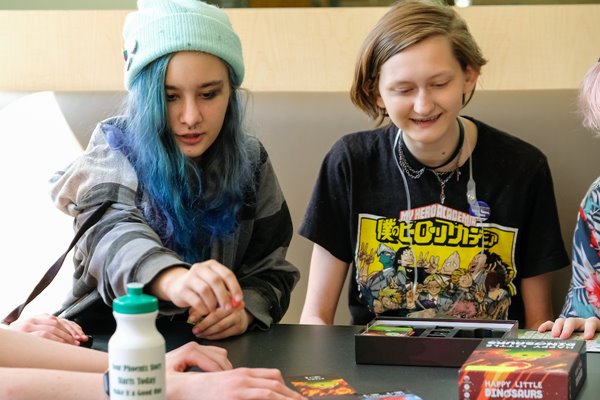 Two pride camp participants work together on at table