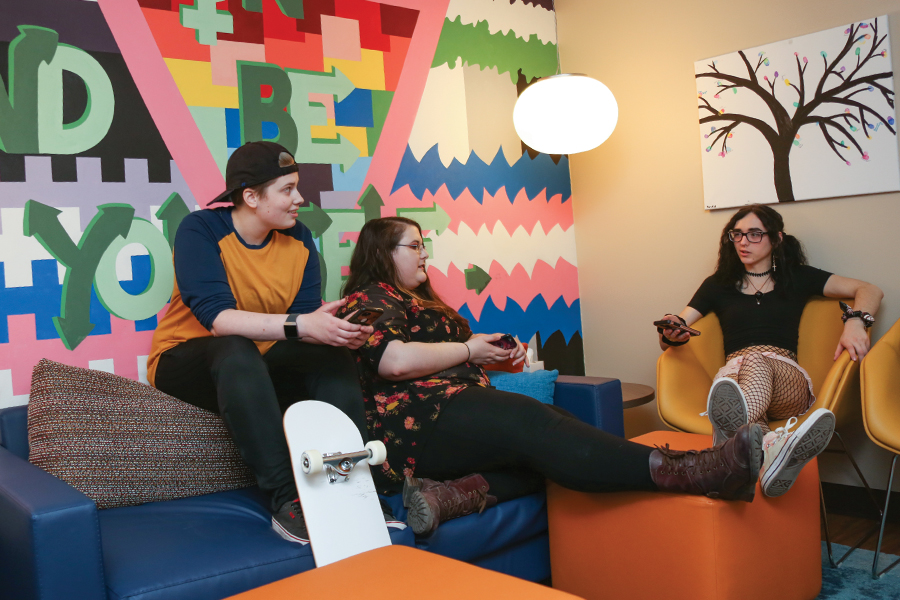 Three students hanging out in the Pride Center