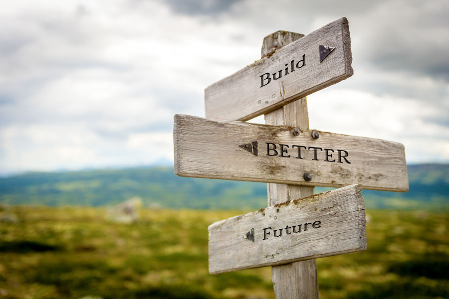 Three way sign with arrows pointing to build, better, and future