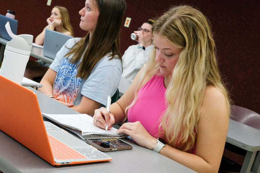 Student taking notes in class