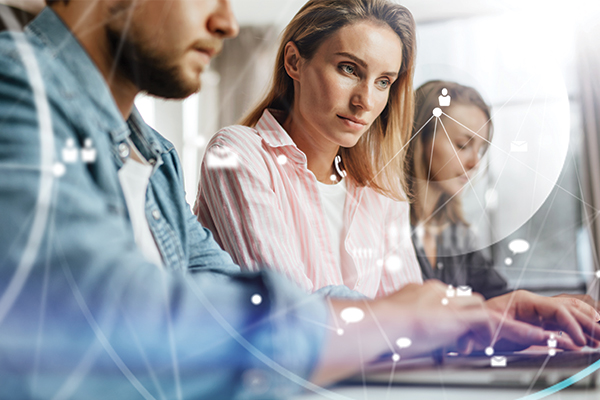 Three people working at computers.