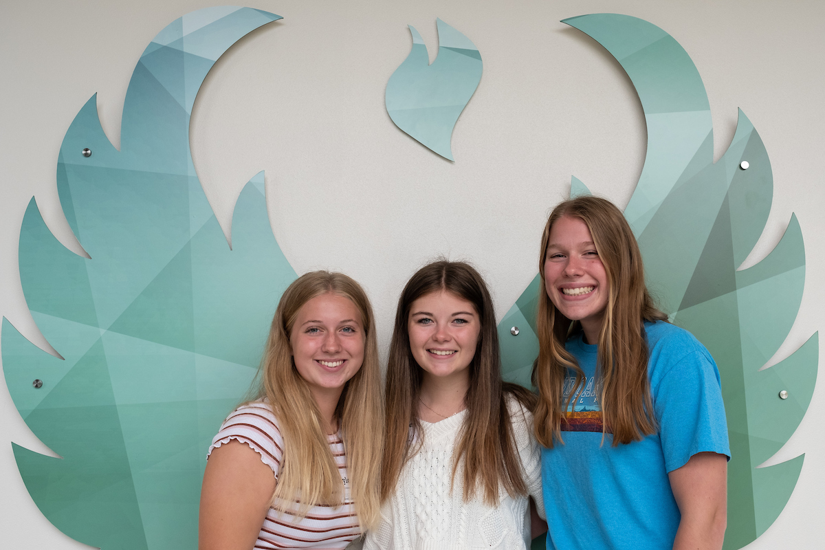 Rising Phoenix students in front of the wings