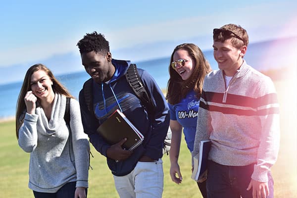 Students walking outside by Lake Michigan