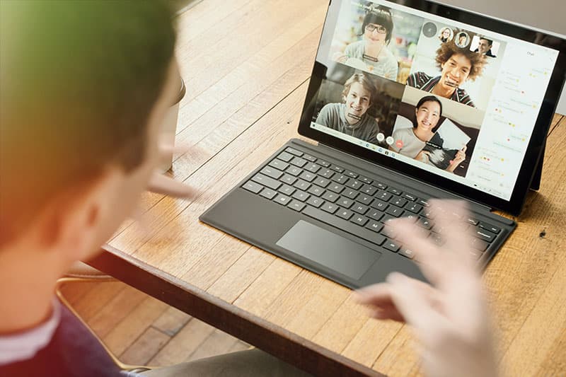 Person hosting virtual meeting with students