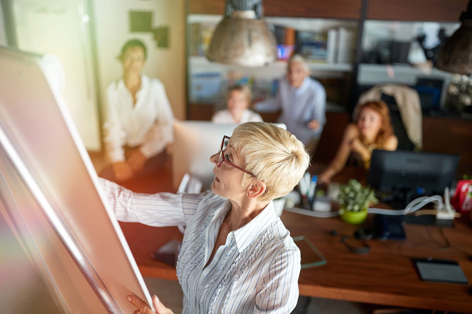 Senior successful business woman leading meeting