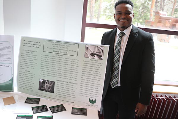 MSW Student Kenny Cyracus presenting his research on rehabilitating children, youth and families