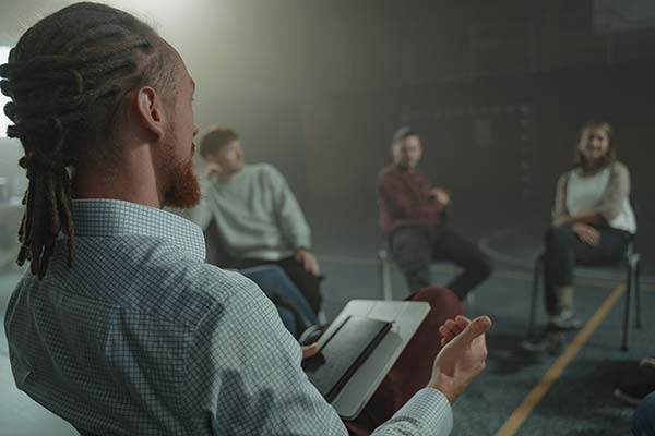 Counselor leading a group therapy support session