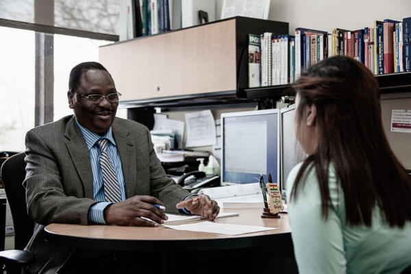 UWGB Social Work Professor Francis Akapko consults a student