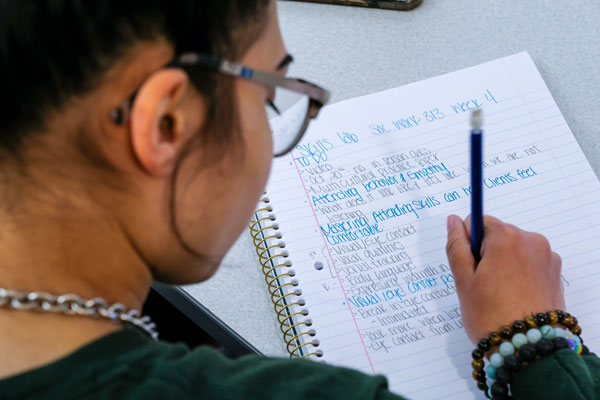 UW-Green Bay student takes notes in class
