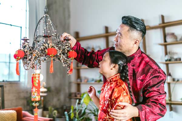 Father and daughter decorate for Chinese New Year