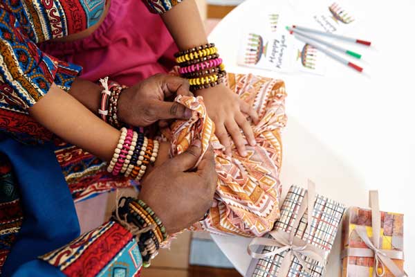 Two people wrap a gift