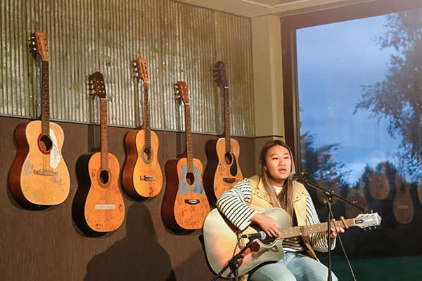 student performing during open mic at the coffeehouse