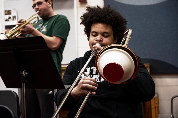 UWGB Sheboygan campus student playing trombone at a band rehearsal