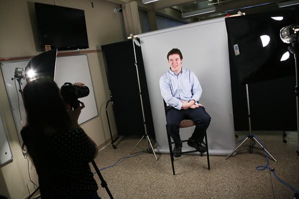 UWGB student getting a professional photo taken at the career services linkedin photo booth