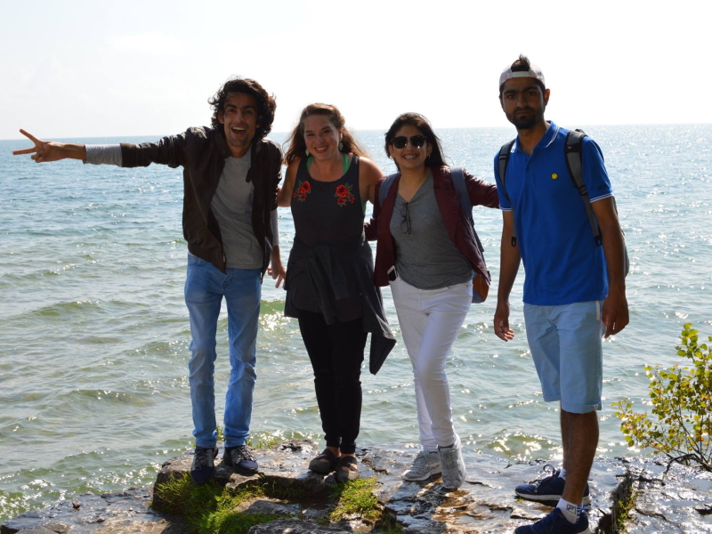 Four people standing on the shore