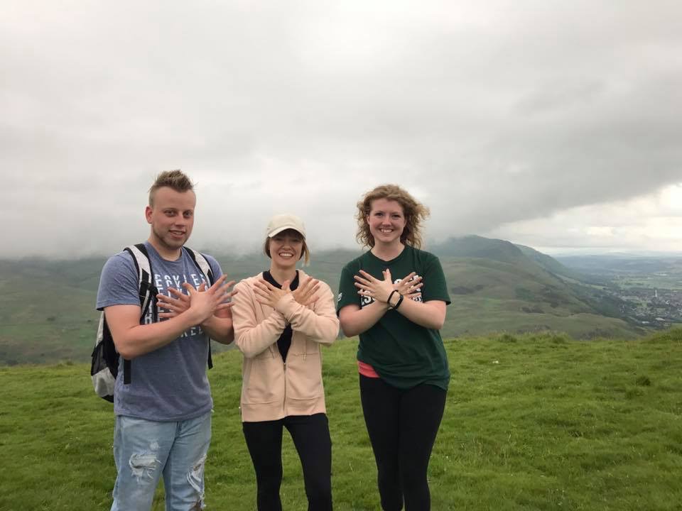 Three students holding up the phoenix