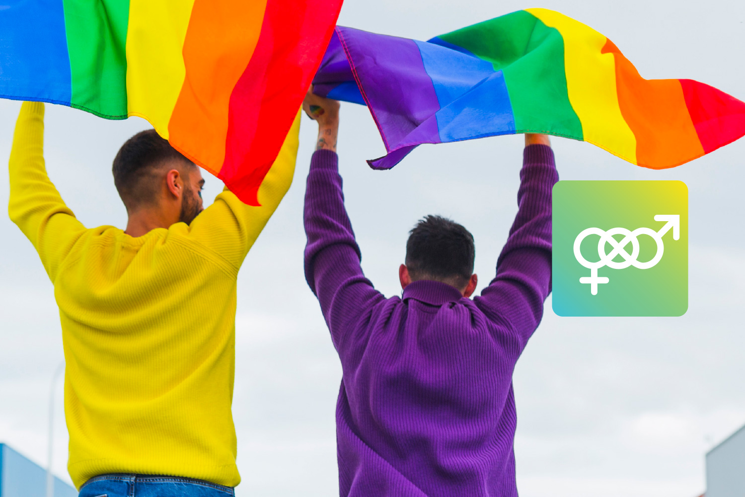 Two people holding rainbow flags