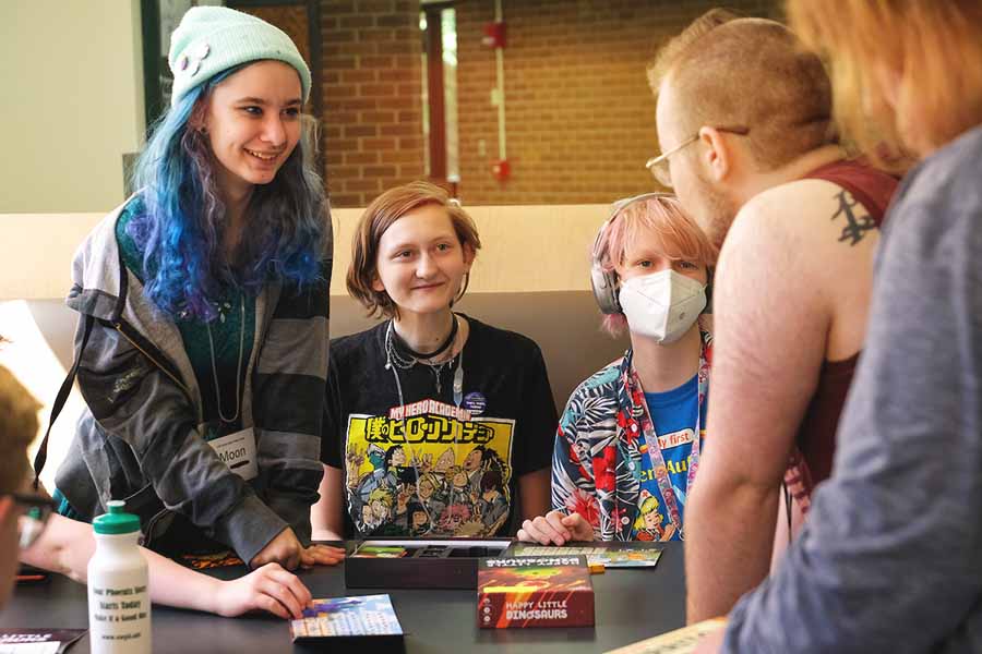 students playing a game and talking during Pride Camp