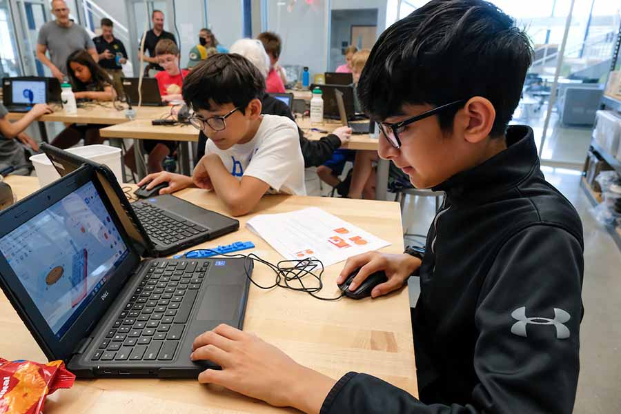 two students looking at laptops during Design Tech